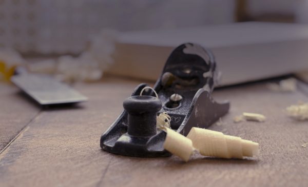 Black wood planing tool on wooden table